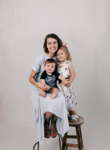A mother and her two children in a studio photo session.